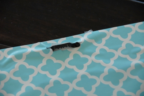Cut slits in the contact paper where the hangers are